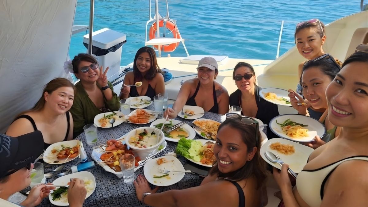 Group of friends enjoying lunch on the deck of SY Shindig